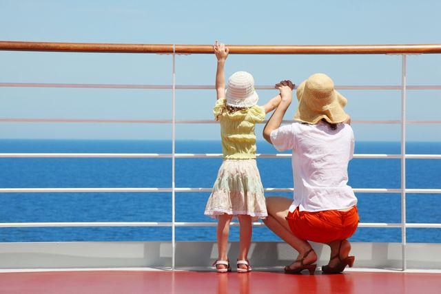 Mother and child looking out to sea from a cruise ship.