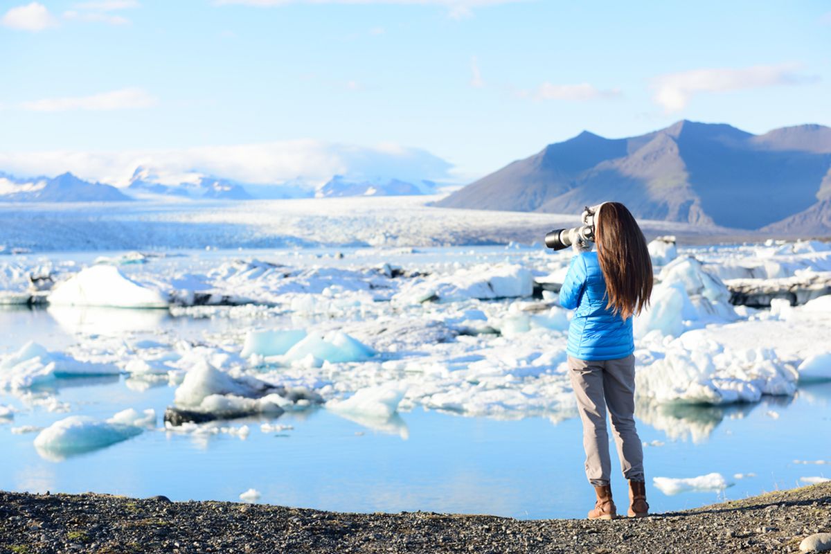 Person using a camera to take a photo of the ice