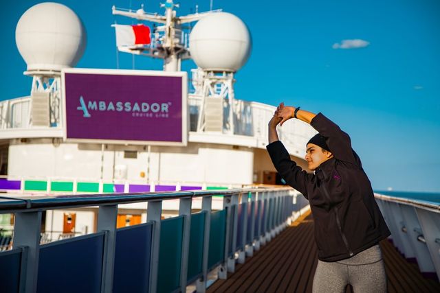 Person stretching on the Ambassador Cruise Line deck