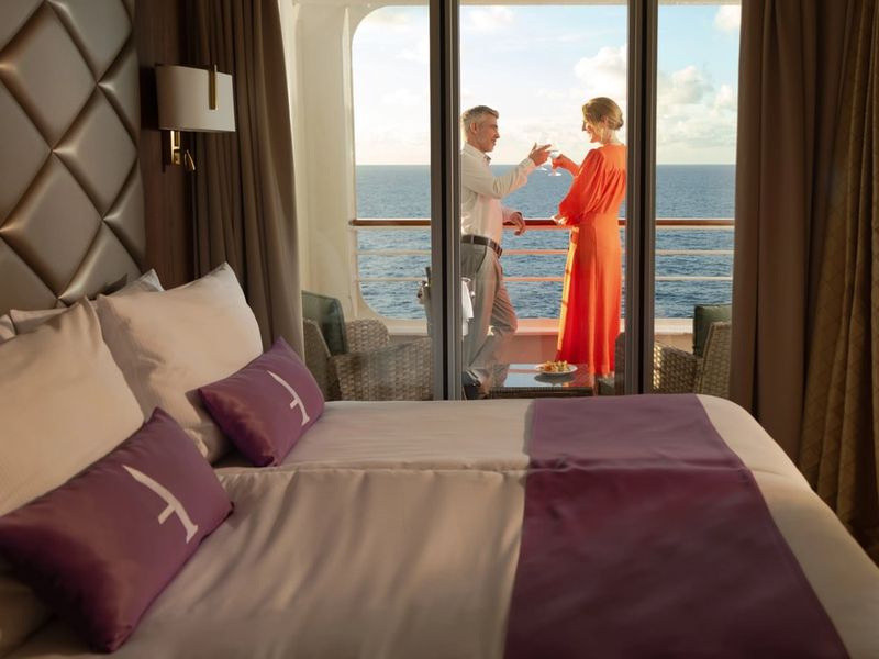 Couple toasting on the suite balcony