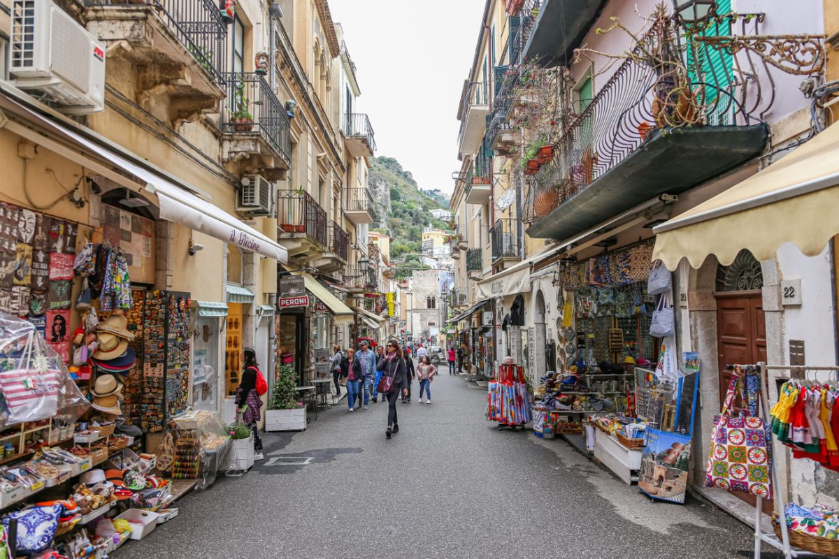 A street lined with souvenir shops in Catania, Sicily, Italy