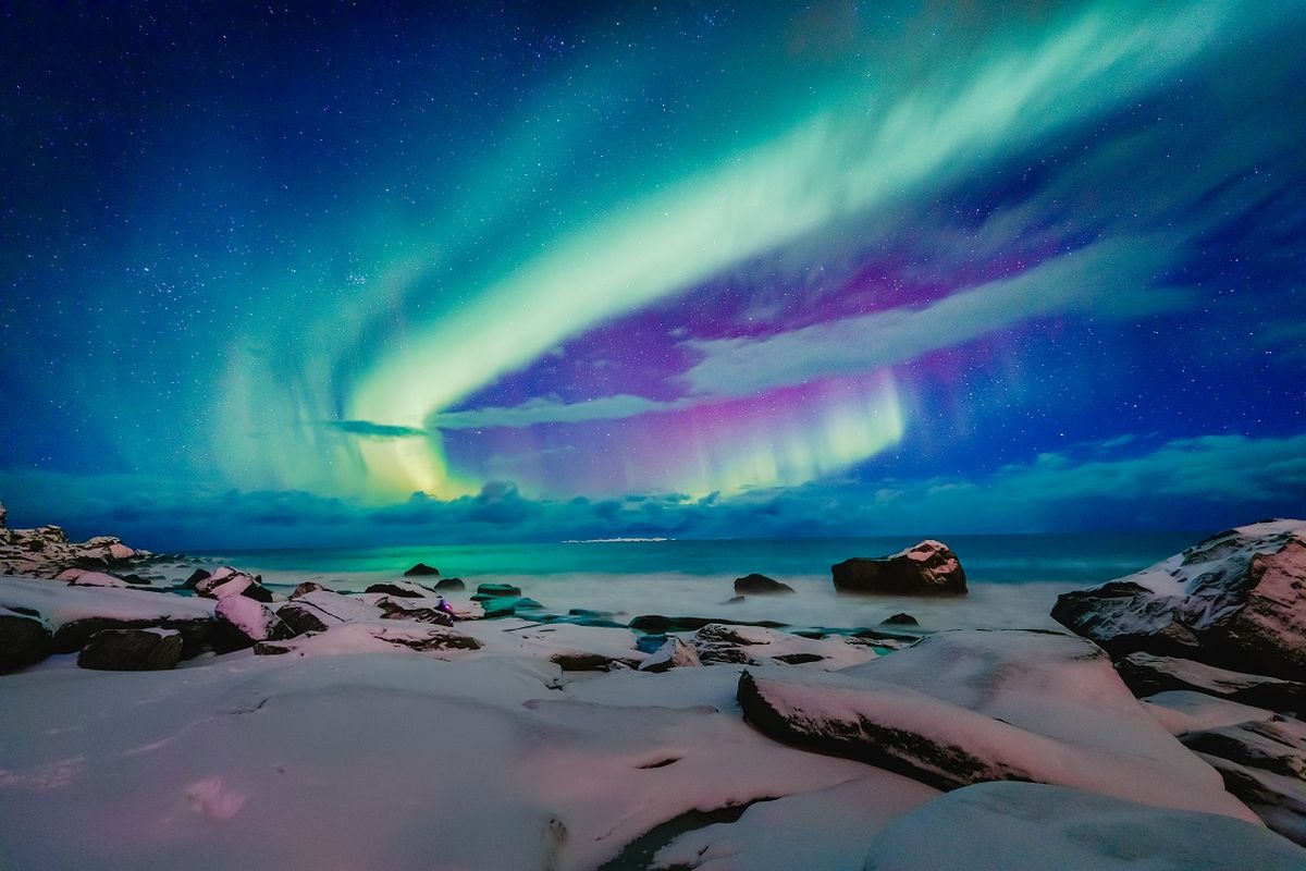 Aurora Borealis over sandy beach on the Lofoten Islands, Norway