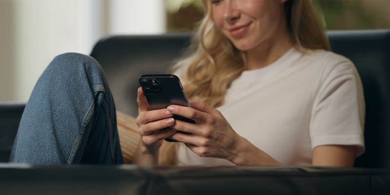 Woman user holding mobile phone and connecting to WiFi