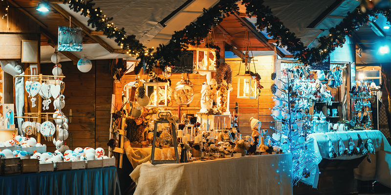 Festive holiday decorations and handicrafts displayed for sale at a Christmas market in Italy