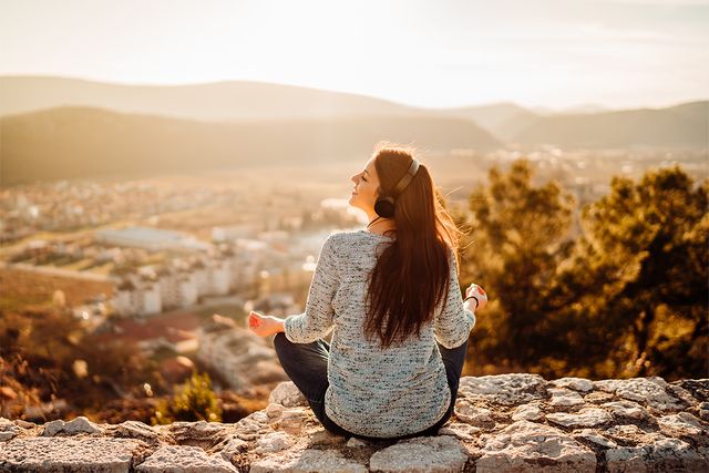 Girl sat listening to podcast