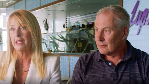 Dawn & Paul sit together in a restaurant with nautical decor.