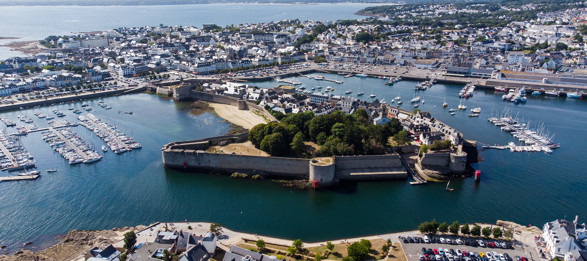 Aerial view of Concarneau, a medieval walled city in Brittany, France - Sandy beach under the fortifications of this island located in a bay along the coast of the Atlantic Ocean