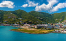 Road Town, Tortola with colorful buildings, nestled at the foot of green hills,
