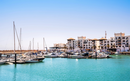Agadir Marina in Morocco. Popular tourist area with luxury apartments, boats in harbor, shops and restaurants. Moroccan seaside resort on shore of Atlantic ocean in Africa