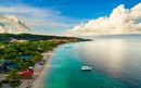 An aerial view of a tropical beach in Roatán Honduras early in the morning.