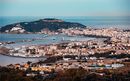 General view of the bay of Ceuta at sunset with Mount Hacho in the background while a ferry enters through the mouth of the port